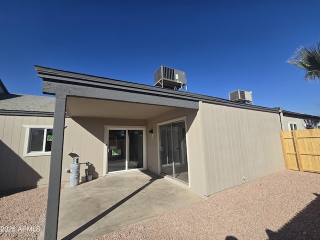 rear view of house with a patio and central AC