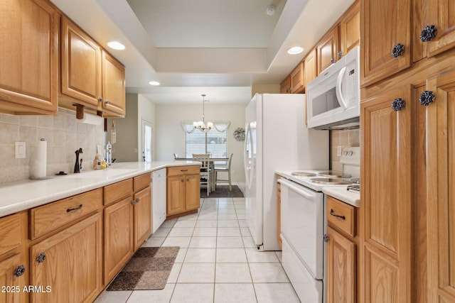 kitchen with hanging light fixtures, light tile patterned floors, white appliances, and decorative backsplash