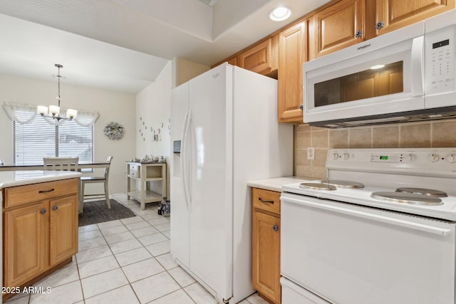 kitchen with hanging light fixtures, light tile patterned floors, a notable chandelier, white appliances, and decorative backsplash