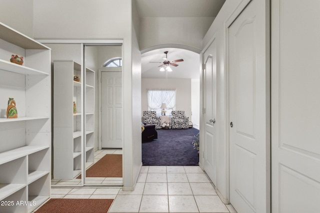 interior space featuring light tile patterned floors and ceiling fan