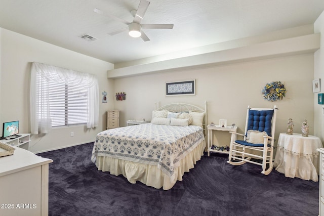 bedroom with ceiling fan and dark carpet