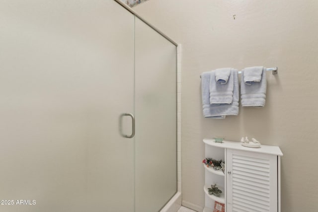 bathroom with a shower with door