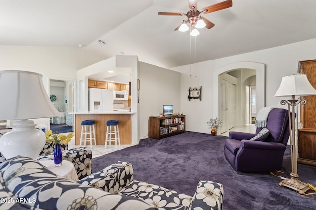 living room with vaulted ceiling, light colored carpet, and ceiling fan