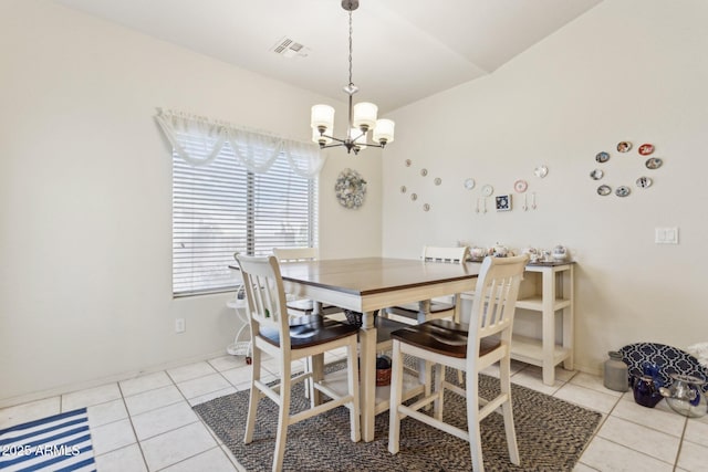 tiled dining space featuring an inviting chandelier