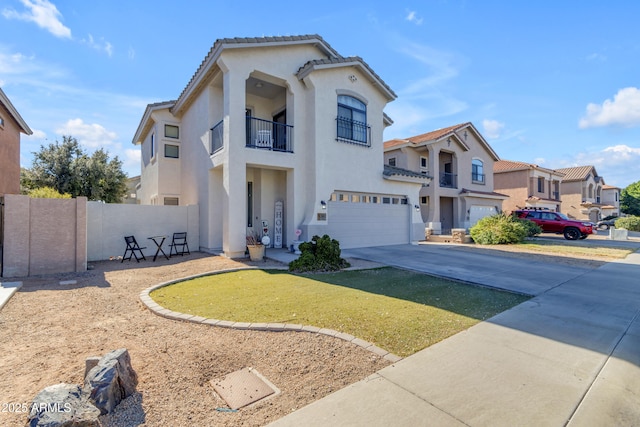 view of front of property featuring a garage, a front yard, and a balcony