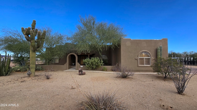 pueblo-style home featuring a patio