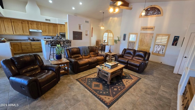 living room featuring ceiling fan and high vaulted ceiling