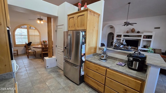 kitchen featuring stainless steel fridge, light tile patterned floors, and ceiling fan