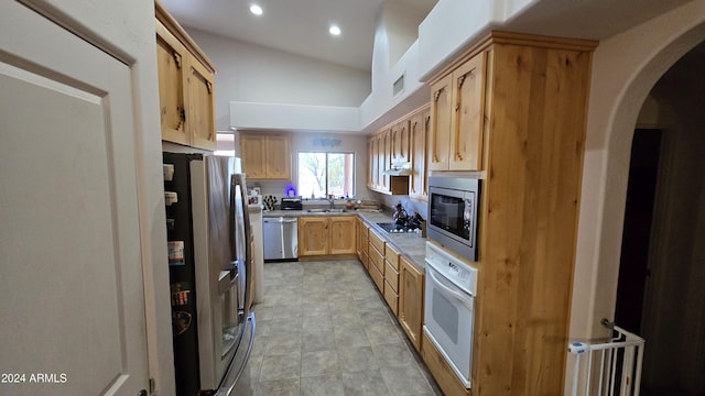 2926 W Tanya Trl, Phoenix, AZ 85086 - kitchen featuring stainless steel appliances, a sink, arched walkways, recessed lighting, and light brown cabinetry