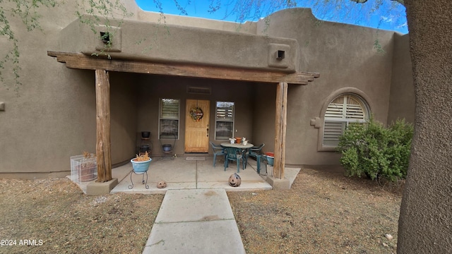 doorway to property featuring a patio area