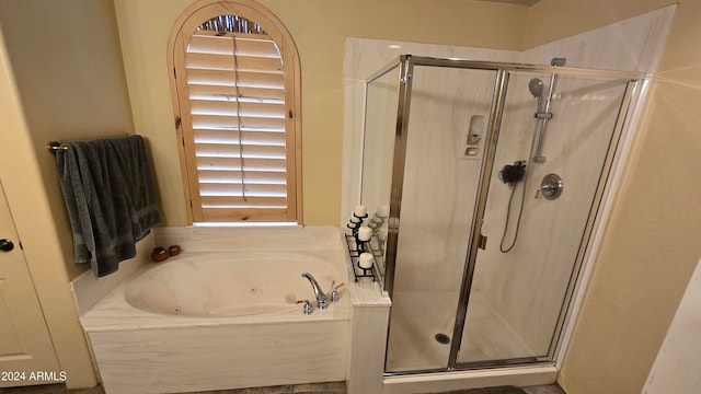 bathroom featuring shower with separate bathtub