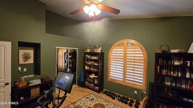 home office with a healthy amount of sunlight, light wood-type flooring, ceiling fan, and lofted ceiling