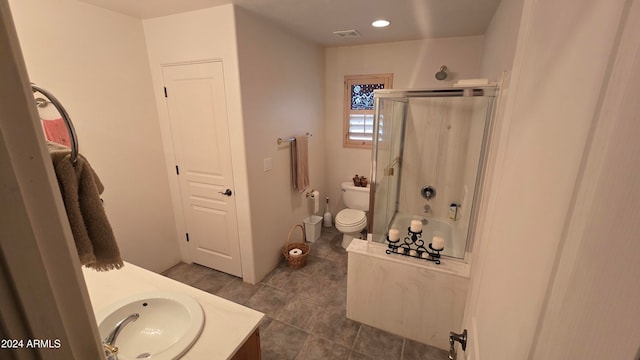 full bathroom featuring tile patterned flooring, shower / tub combination, vanity, and toilet