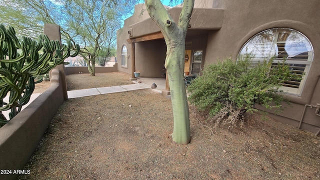 view of property exterior with a patio area