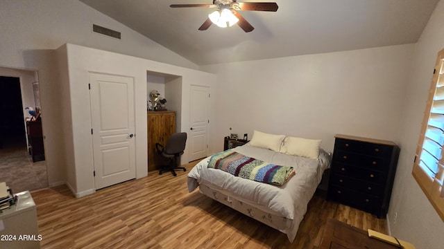 bedroom with ceiling fan, vaulted ceiling, and hardwood / wood-style flooring