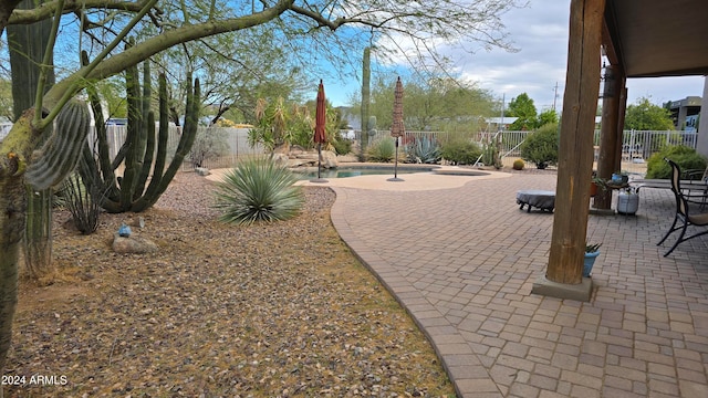 view of property's community with a swimming pool and a patio