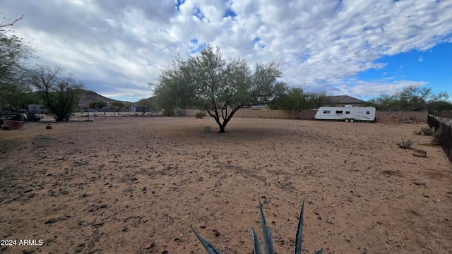 view of yard with a mountain view and a rural view