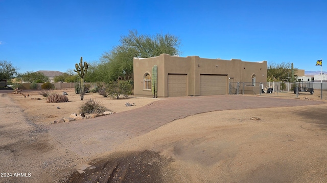 southwest-style home featuring a garage