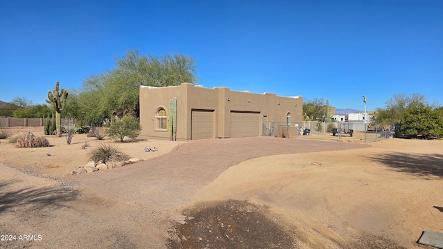 pueblo-style home featuring a garage