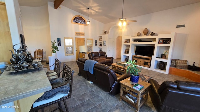 tiled living room featuring ceiling fan, beamed ceiling, and high vaulted ceiling