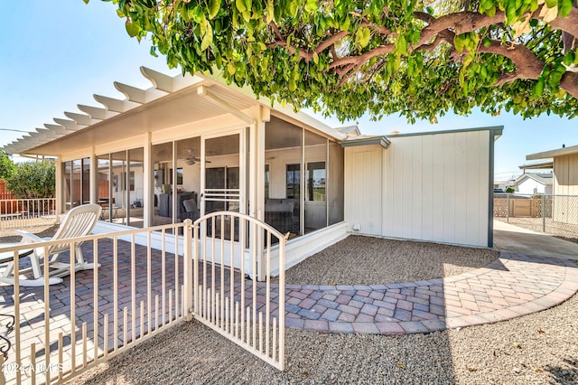 rear view of house with a sunroom and a patio area