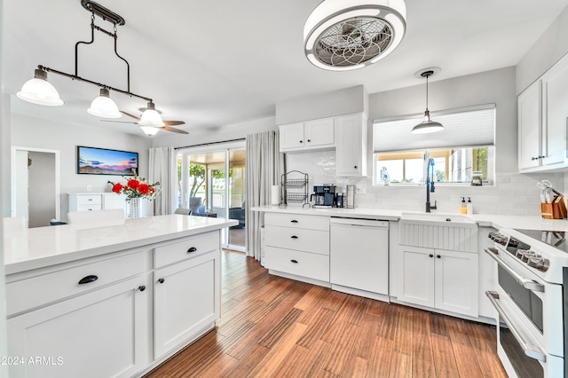 kitchen featuring a wealth of natural light, white appliances, and white cabinets