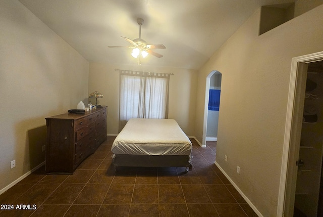 tiled bedroom with lofted ceiling and ceiling fan