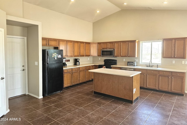 kitchen with dark tile patterned flooring, high vaulted ceiling, a kitchen island, black appliances, and sink