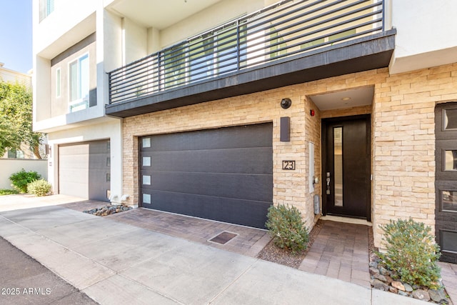 view of front facade featuring a balcony and a garage