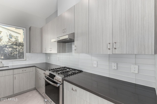 kitchen with decorative backsplash, light brown cabinetry, stainless steel gas stove, and light tile patterned floors