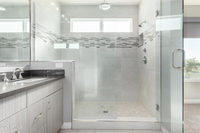 bathroom featuring vanity and an enclosed shower