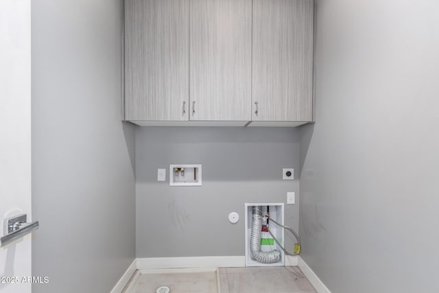 clothes washing area featuring cabinets, washer hookup, electric dryer hookup, light tile patterned floors, and hookup for a gas dryer