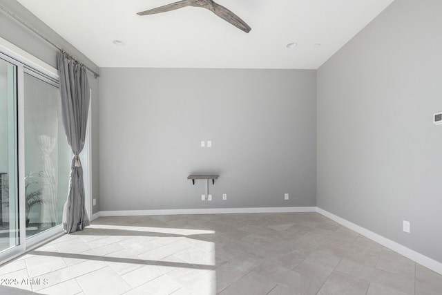 unfurnished room featuring ceiling fan and light tile patterned flooring