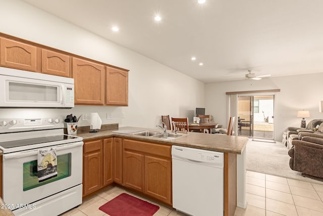 kitchen with recessed lighting, a peninsula, white appliances, a sink, and open floor plan