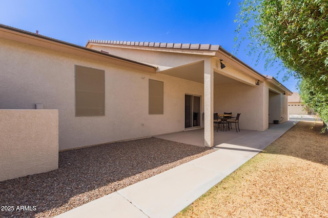 back of house featuring a patio and stucco siding