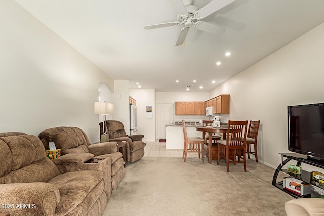 living room with light tile patterned floors, recessed lighting, a ceiling fan, and light colored carpet