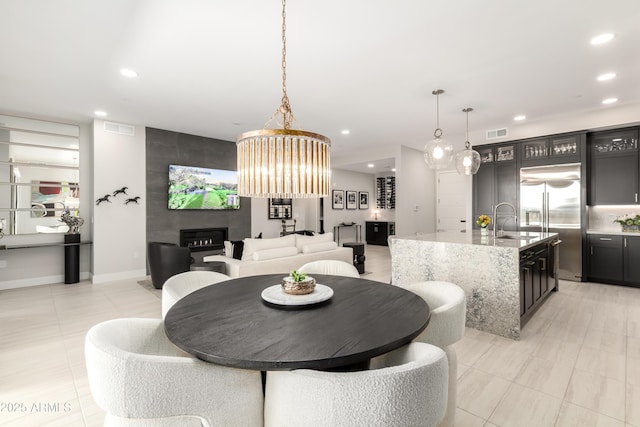 5250 E Deer Valley Dr Unit 146, Phoenix, AZ 85054 - dining room featuring recessed lighting, a fireplace, and light tile patterned flooring