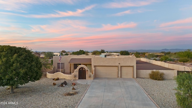 pueblo-style home with a garage