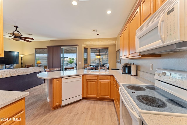 kitchen featuring white appliances, hanging light fixtures, ceiling fan, light wood-type flooring, and kitchen peninsula