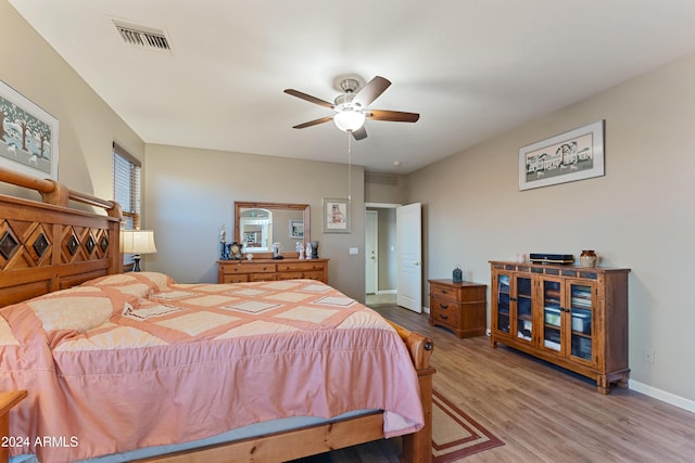 bedroom with ceiling fan and light hardwood / wood-style flooring