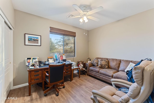 home office featuring light hardwood / wood-style floors and ceiling fan