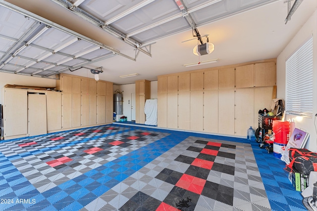 garage with secured water heater and a garage door opener