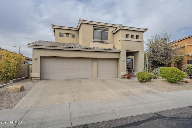 4864 E Eden Dr, Cave Creek, AZ 85331 - mediterranean / spanish home featuring a tile roof, a garage, concrete driveway, and stucco siding