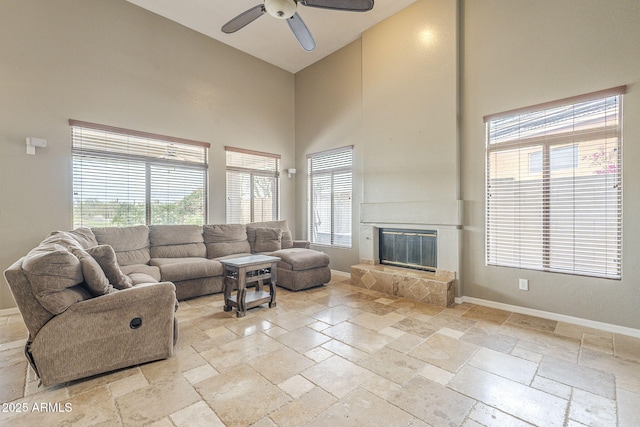 4864 E Eden Dr, Cave Creek, AZ 85331 - living area with baseboards, a towering ceiling, a large fireplace, and stone tile floors