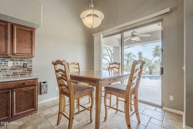 4864 E Eden Dr, Cave Creek, AZ 85331 - dining room featuring stone tile floors, baseboards, and ceiling fan
