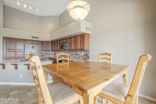 4864 E Eden Dr, Cave Creek, AZ 85331 - dining room featuring a towering ceiling, stone tile floors, baseboards, and visible vents
