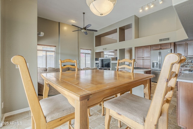 4864 E Eden Dr, Cave Creek, AZ 85331 - dining space with baseboards, visible vents, high vaulted ceiling, and ceiling fan