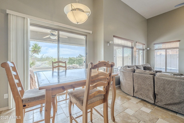 4864 E Eden Dr, Cave Creek, AZ 85331 - dining area featuring baseboards, ceiling fan, a high ceiling, and stone tile floors