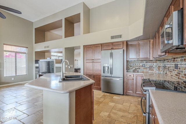 4864 E Eden Dr, Cave Creek, AZ 85331 - kitchen featuring visible vents, baseboards, appliances with stainless steel finishes, a sink, and stone tile floors