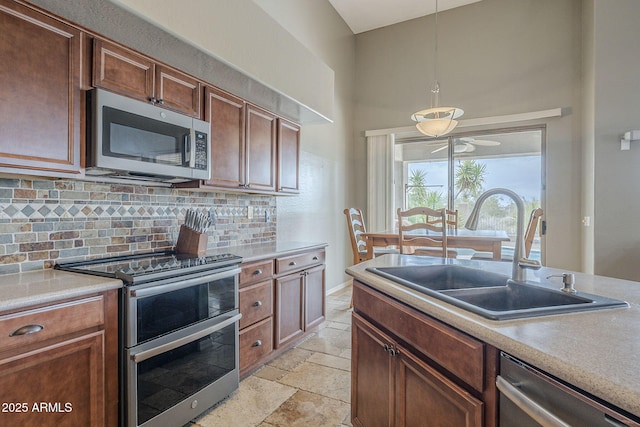 4864 E Eden Dr, Cave Creek, AZ 85331 - kitchen with light countertops, stainless steel appliances, backsplash, a sink, and stone tile flooring